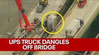 UPS truck dangles off Indiana bridge after bizarre crash