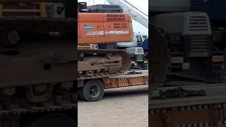 excavator unloading from a trailer in different style