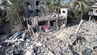 Drone shows damage caused by strikes in central Gaza, displaced people crowd streets