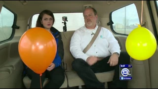 Floating helium balloon in a moving car