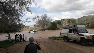 LANDCRUISER PULLING TRUCK OUT OF RIVER