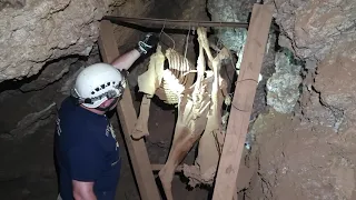 old hand-dug abandoned underground mine with disassembled animal candles slo-mo bats