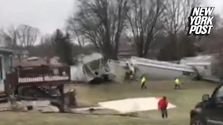 Gigantic train derails in Iowa family's backyard