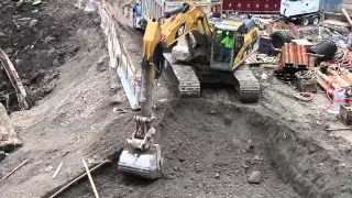 Cat 330DL Excavator Loading Dirt into Dump Truck