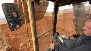 Caterpillar 245B Excavator Loading Trucks With Three Passes