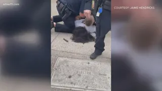 Louisville police officer under investigation after video appears to show him repeatedly punching ma