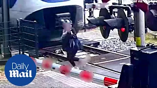 CLOSE CALL: Heart-stopping moment a woman cheats death as train approaches