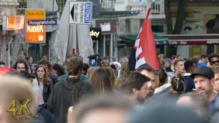 Anarchists red and black flags floating above crowd in European city