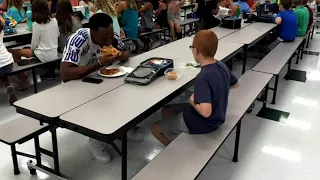 Photo showing FSU football player eating lunch with autistic boy goes viral