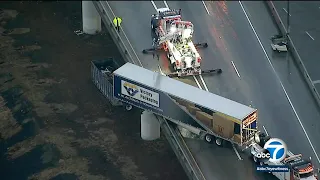 Wreck leaves big rig dangling off bridge in East LA | ABC7