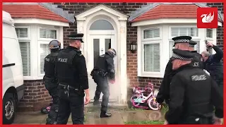 Footage captures the moment police use a saw to break down a door in Liverpool