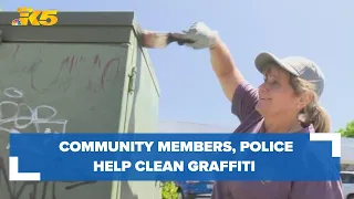 Community members and Tukwila police officers team up to remove recent graffiti