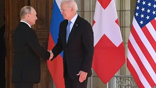 Biden and Putin shake hands at summit venue