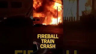 Flames erupt after train collides with truck