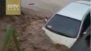 Footage: Dozens of vehicles swept away by flood in southern China