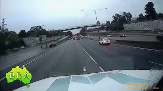 BAD Driving Australia - BMW driver exits freeway at speed, how did they not lose control in the wet!