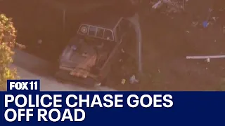 Police chase suspect goes off road, crashes underneath overpass in LA County