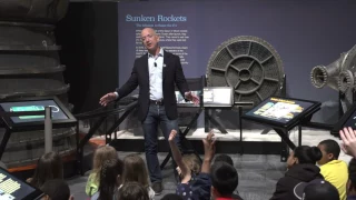 Jeff Bezos speaks with students at the opening of the Apollo exhibit at The Museum of Flight