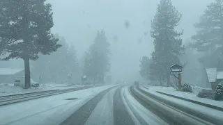 Snowing heavy in Big Bear Lake, CA. Snow drive around the lake. Slick roads. Be careful. 2/12/2021.