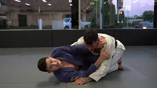 LOOP CHOKE WITH THUMB DOWN FROM HALF GUARD