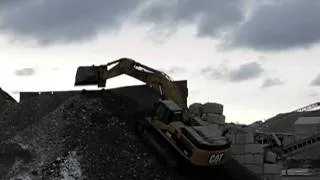 Cat 345DL Excavator climbing pile