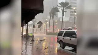 Billboard flies across Canal Street in New Orleans as Hurricane Ida's winds hit the French Quarter