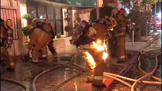 Firefighter catches fire while battling a structure fire in Sherman Oaks, California. (Not injured).