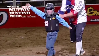 Proud child waves after Mutton Busting ride at San Antonio Stock Show & Rodeo