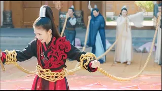 Kung Fu Movie: A bully traps a woman with iron chain, but she breaks it free, defeating everyone.