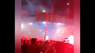 Angel Di Maria wielding a firecracker and celebrating with PSG fans