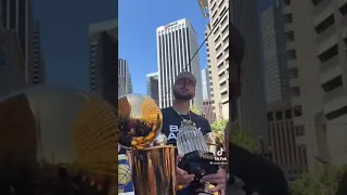 Curry smoking cigar in crowd with Trophies 🏆