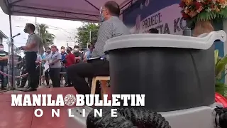 Manila Mayor samples a toilet during the launching of Kubeta Project