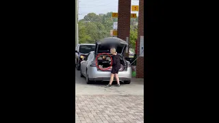 Girl tries to put gas in her Tesla at the gas station