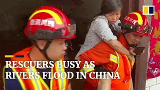 Firefighters rescue people from flooded homes in China as heavy rainfall swells  rivers