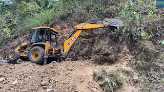 Struggle Cutting Rocky and Gravelly Hillside While Making Mountain Road