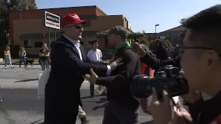 RAW VIDEO: Donald Trump supporter walks through angry crowd of protesters