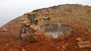 Caterpillar D11R pushing a massive rock 2