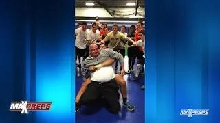 Coach challenges player to wrestling match