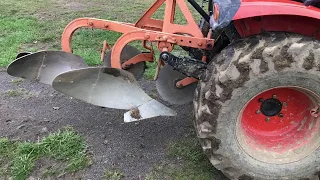 Compact tractor plowing with a 2 bottom plow