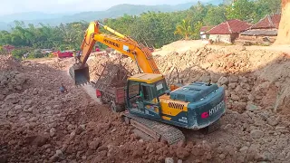 Build high and hilly road constructions by scraping rocks loaded into trucks