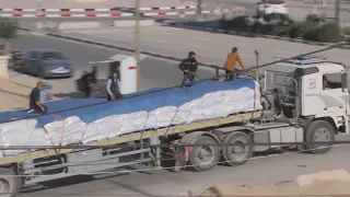 People seen scrambling for aid as trucks enter Gaza through Rafah border crossing