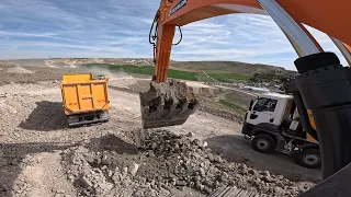 DEVELON Excavator She loads stony materials onto trucks.