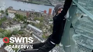 Daredevil hangs from a London skyscraper with his fingertips | SWNS