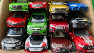 Box full of Diecast cars, Bentley, Supra, Honda Fit, Jaguar, BMW, Ford.