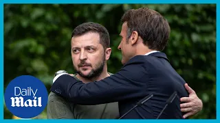 Moment Zelensky and Macron share awkward embrace at European leaders meeting