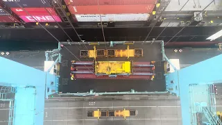 Loading containers on deck in windy conditions with a Gantry Crane.