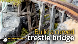 Build a curved trestle bridge over fake rocks on an N scale model railway