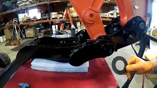 attaching a quick coupler onto a Kubota excavator