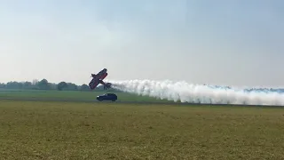 Rich goodwin Pitts biplane racing a Jag at Abingdon