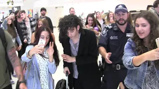 Matt Healy & The 1975 are mobbed by fans as they depart Adelaide airport on Australian tour in 2015